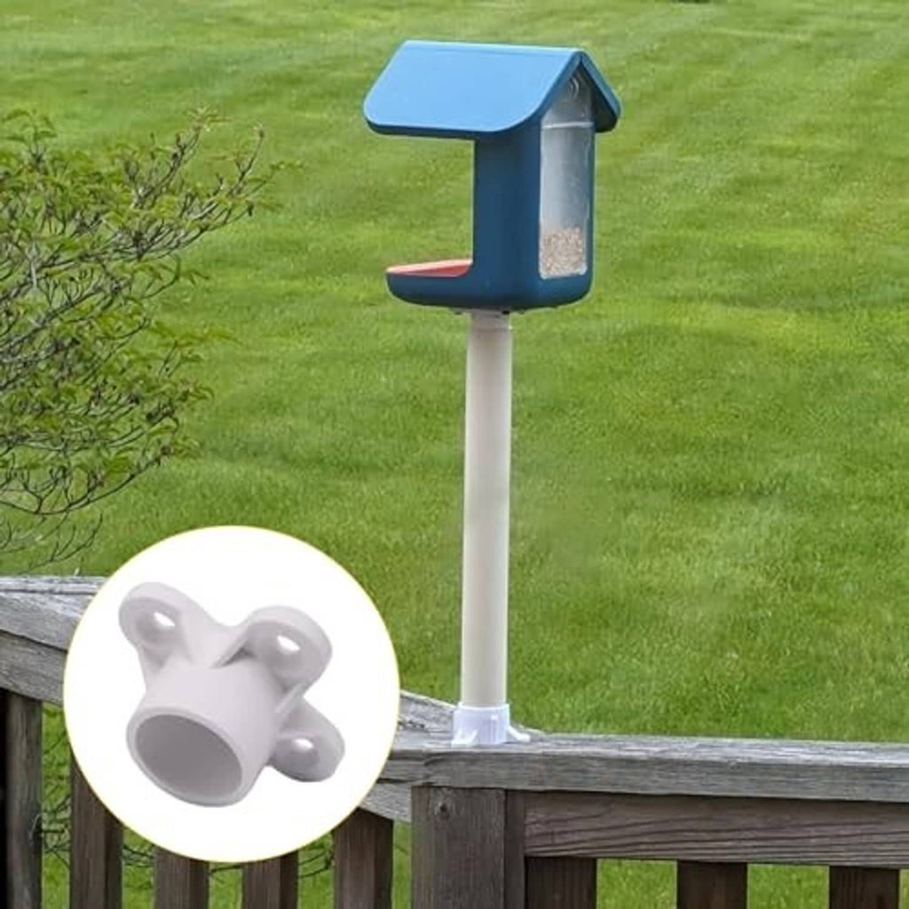 White PVC pipe flange cap fitting installed on a vertical post with round cap opening
