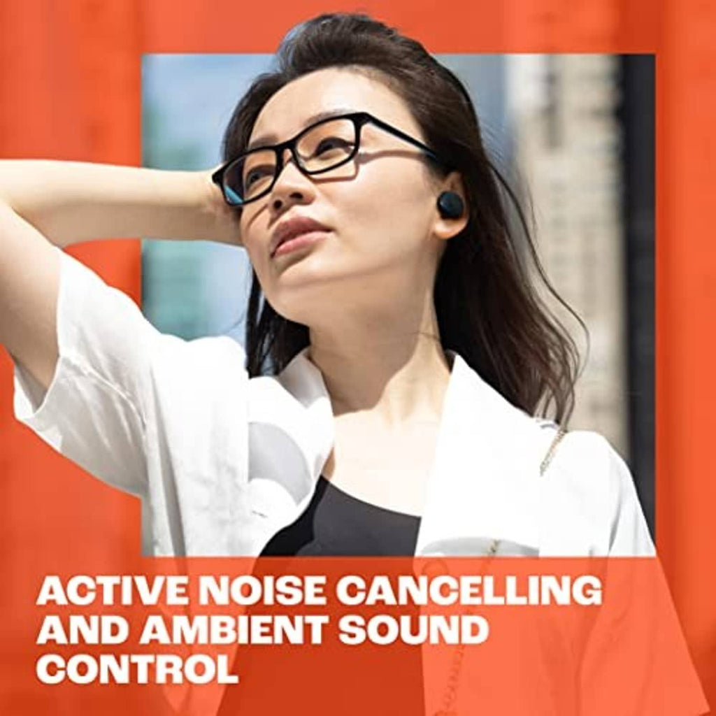 Woman wearing black JBL true wireless earbuds while adjusting her glasses.