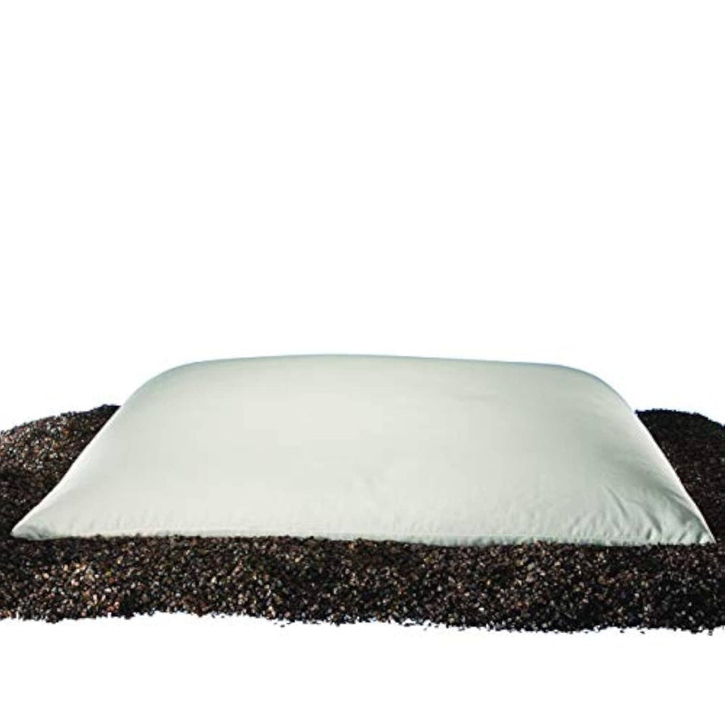 Buckwheat hull pillow with white cover, front view on dark hull bed