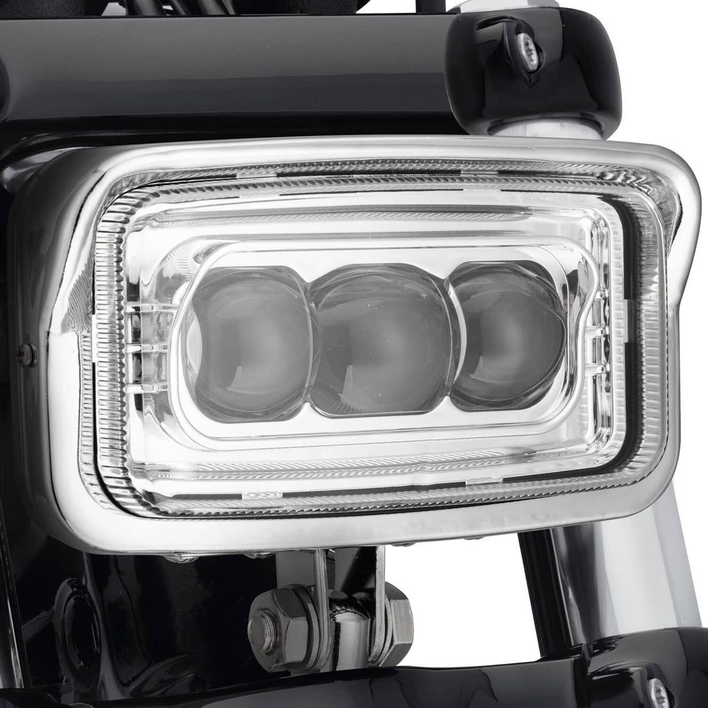 Chrome rectangular front LED headlight with three lens sections and clear cover glass
