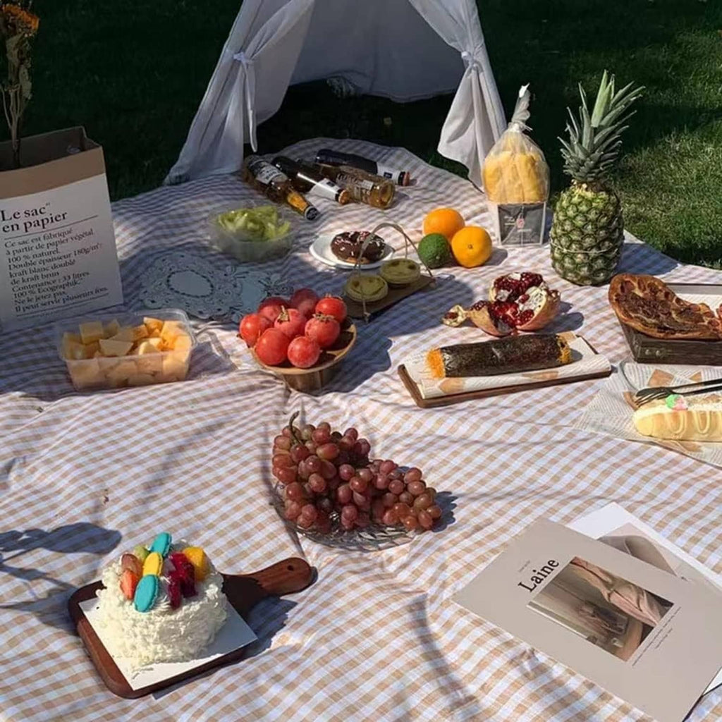 Extra-large picnic blanket laid out outdoors in brown and white check pattern