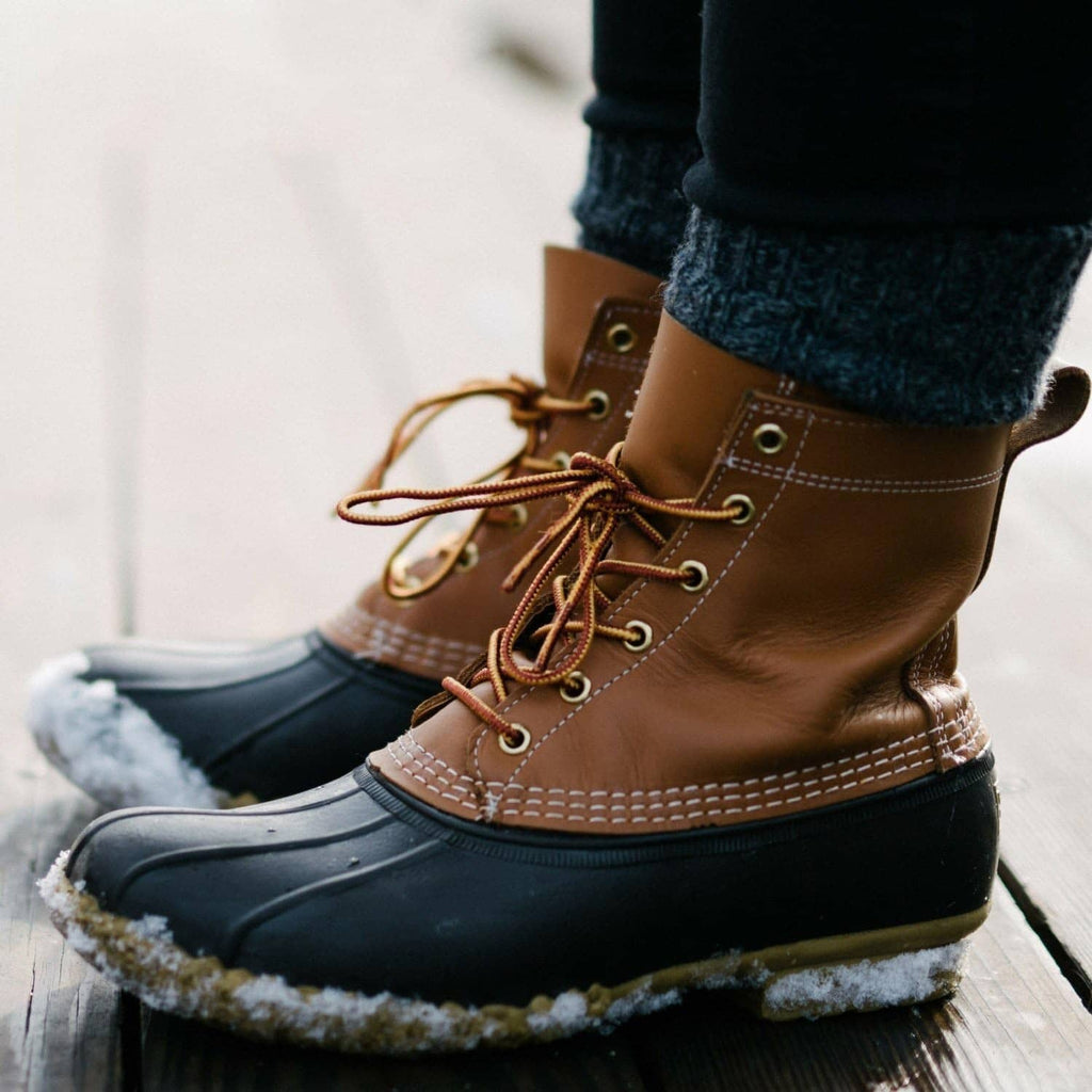 Foot wearing ultra-thin dark insole foot warmer in brown lace-up boot
