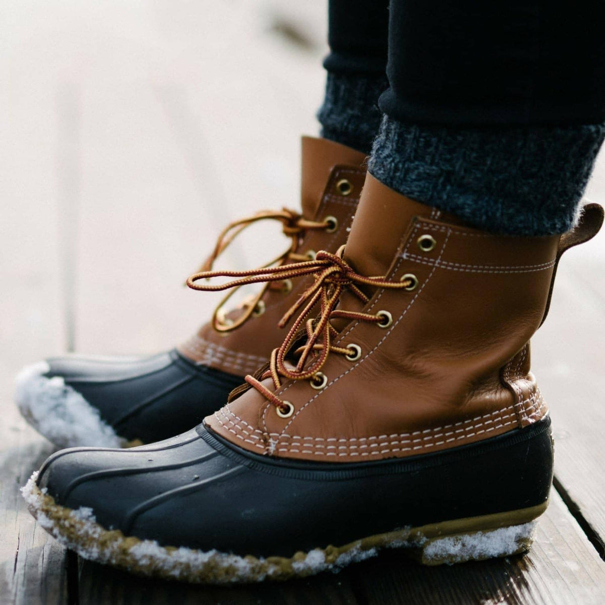 Foot wearing ultra-thin dark insole foot warmer in brown lace-up boot