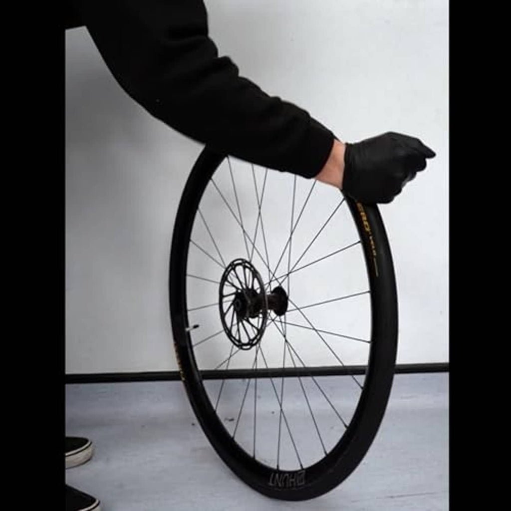 Bicycle wheel with black tire, tube installation demo by hand