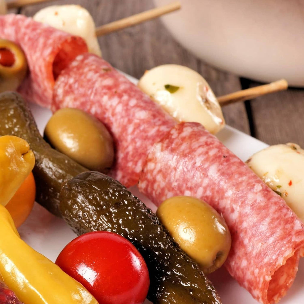 Summer sausage log with jalapeno, served with olives and cheese cubes on skewers