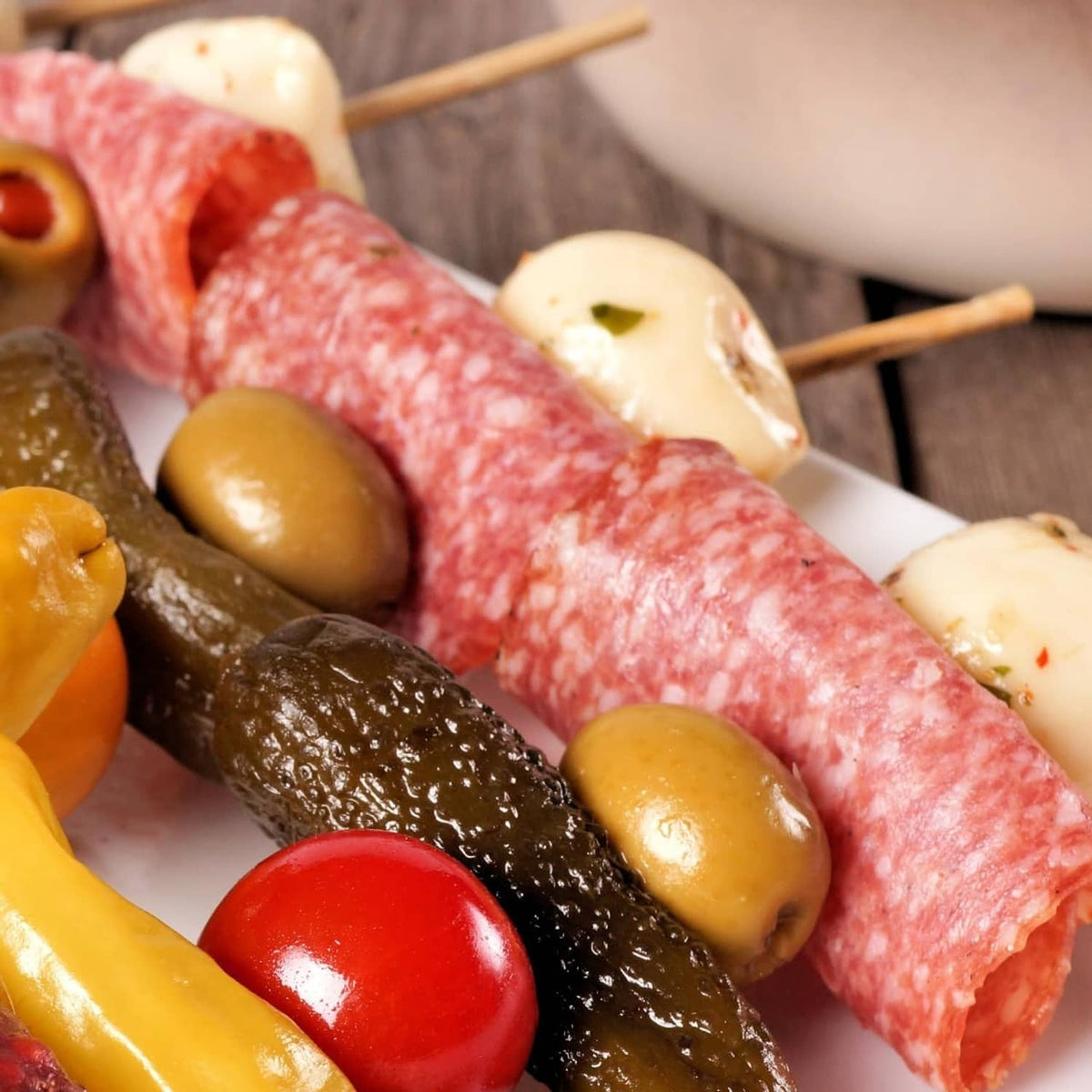 Summer sausage log with jalapeno, served with olives and cheese cubes on skewers