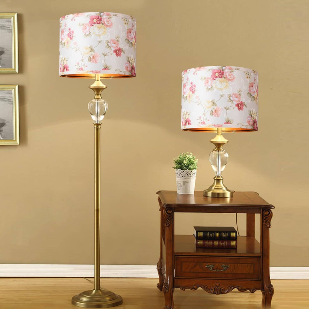 Pair of floral drum lamp shades with pink rose print and black top fitter