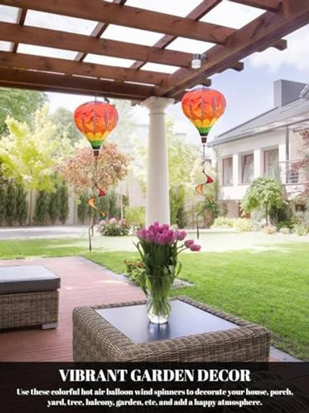 Rainbow hot air balloon wind spinner pair hanging outdoors with swirled ribbon tails