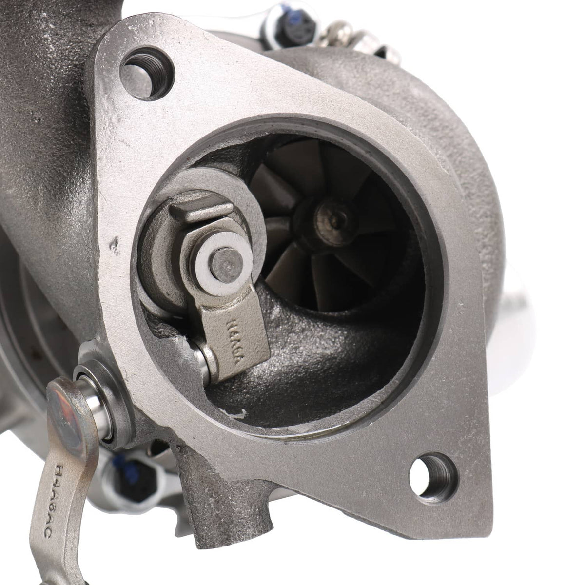 Turbocharger turbine housing close-up with circular opening and metal V-band component
