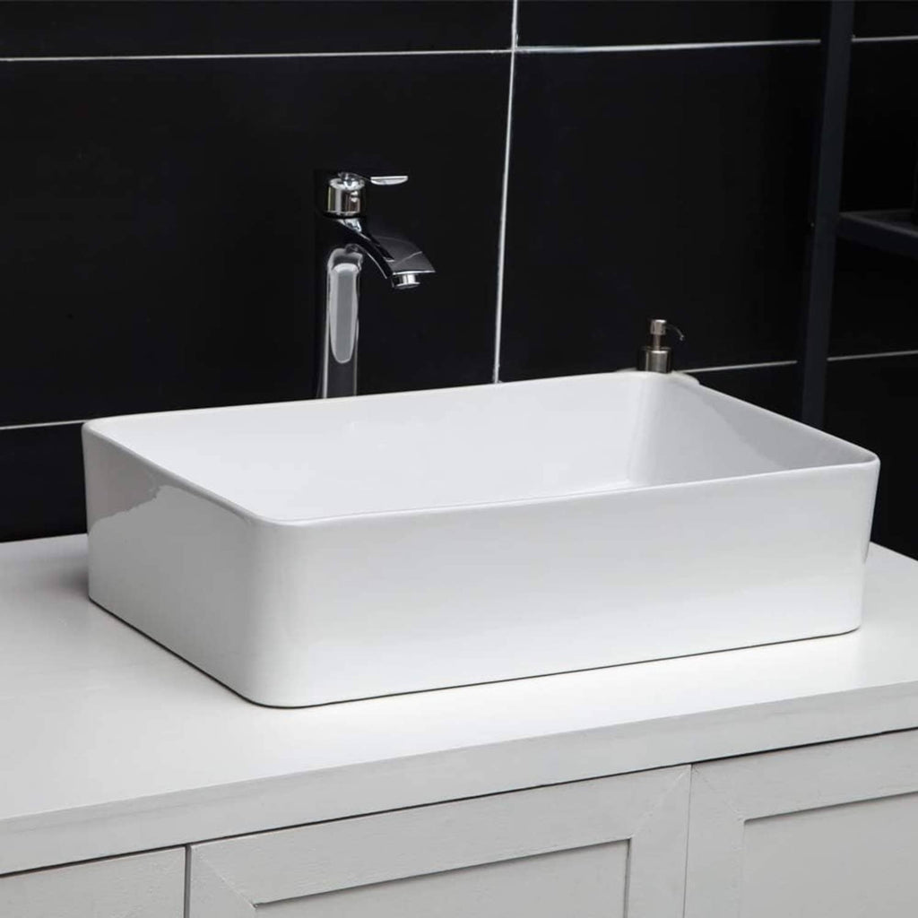 White rectangular bathroom vessel sink with tall chrome faucet and front drain opening