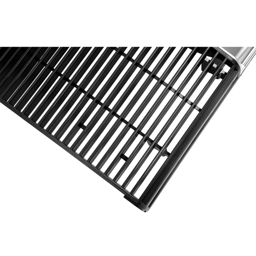 Close-up of tractor grille slats with black bars and silver frame edge at corner
