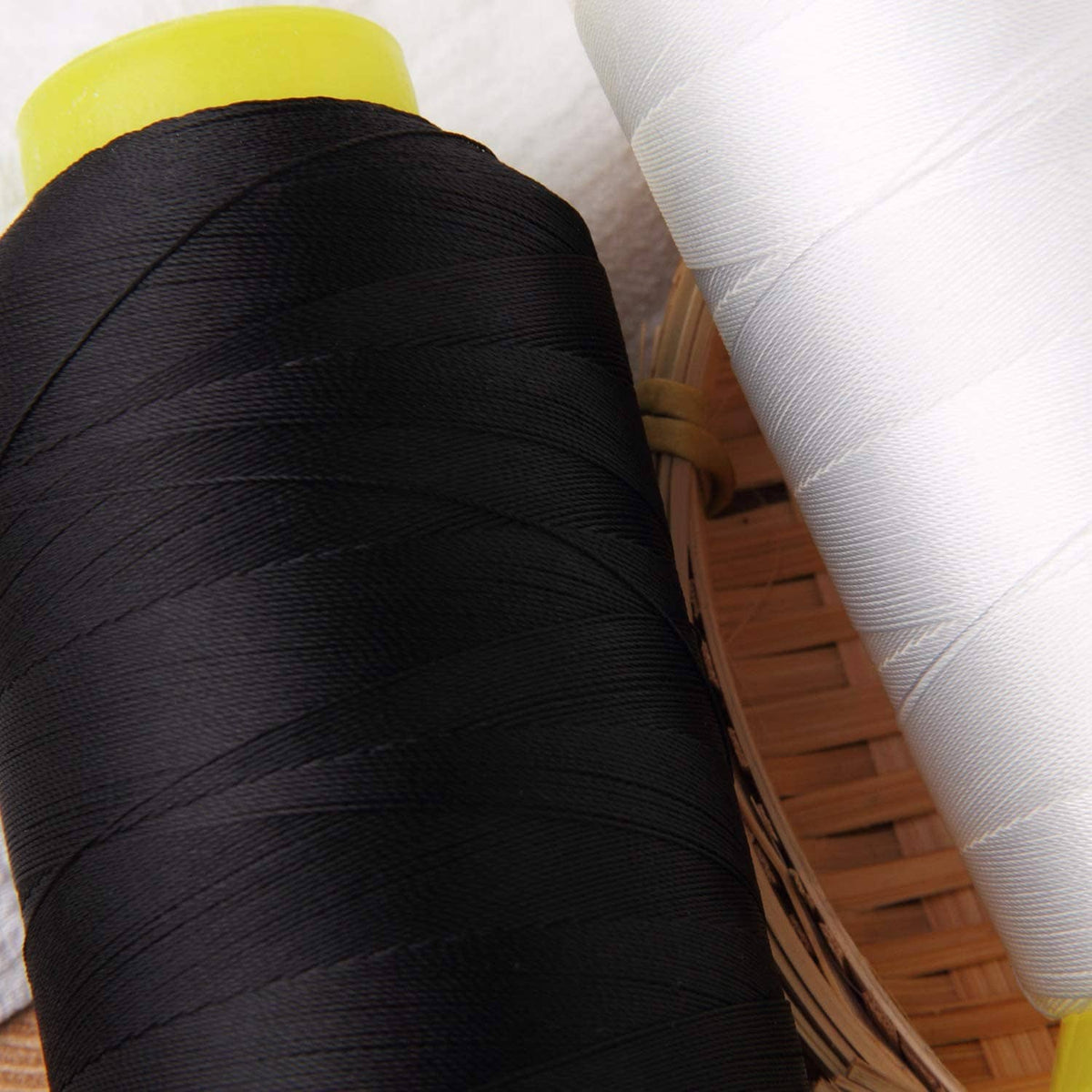 Black bonded nylon sewing thread spool with close-up wound thread