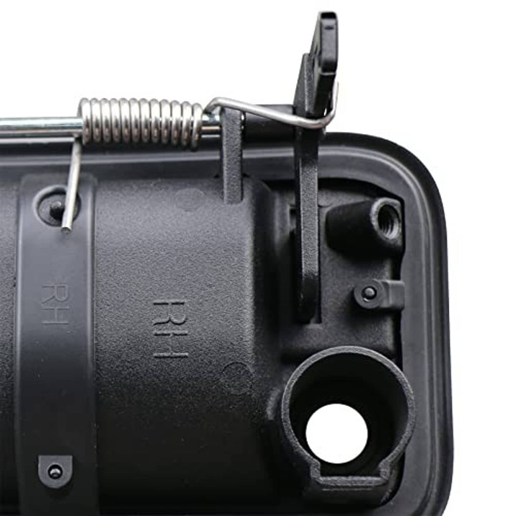 Close-up of black door handle housing with metal spring linkage and mounting hole