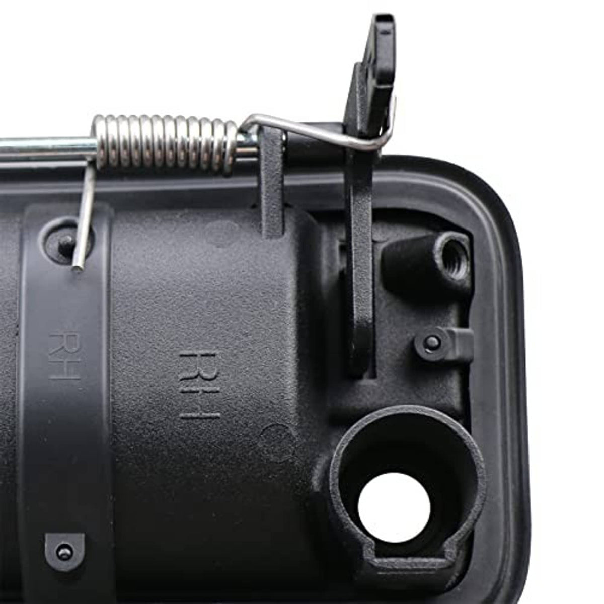 Close-up of black door handle housing with metal spring linkage and mounting hole