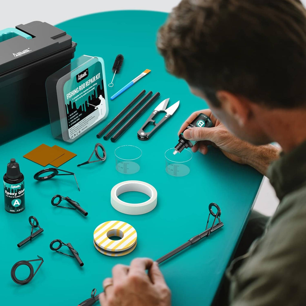 Fishing rod repair kit on worktable with parts, glue bottle, and hands preparing