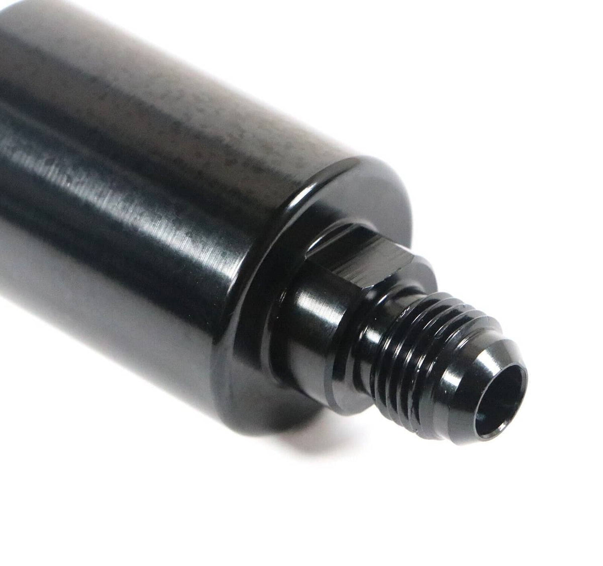 Inline AN6 fuel filter outlet close-up with black fittings and threaded connector