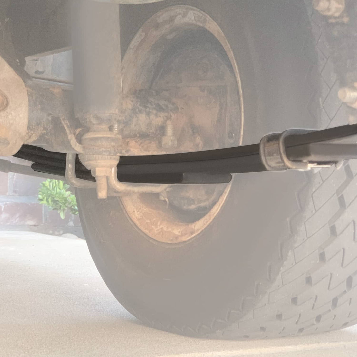 Rear leaf spring assembly with black steel bar and axle mounting hardware