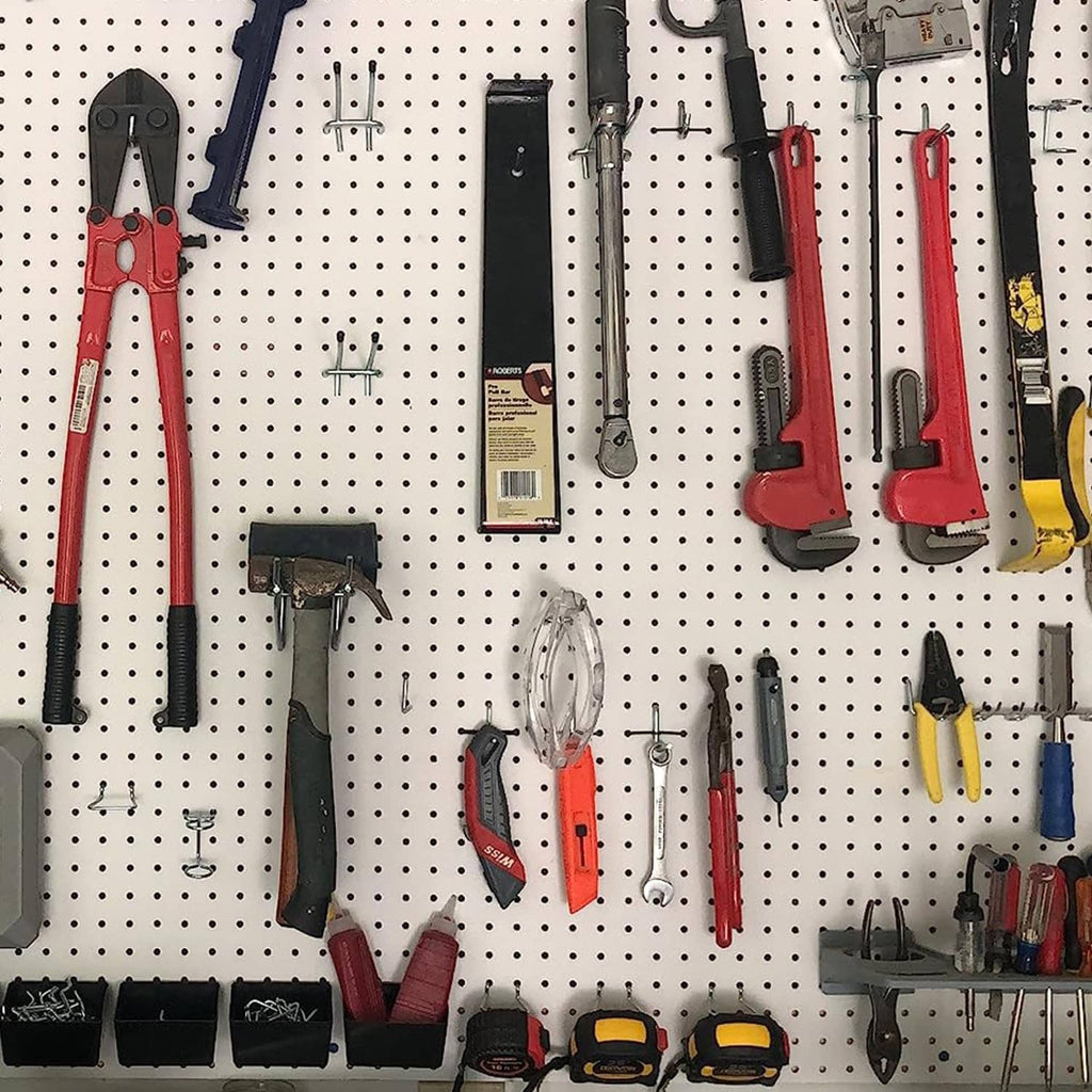 Pegboard wall with hanging tools on hooks and rails plus black storage bins
