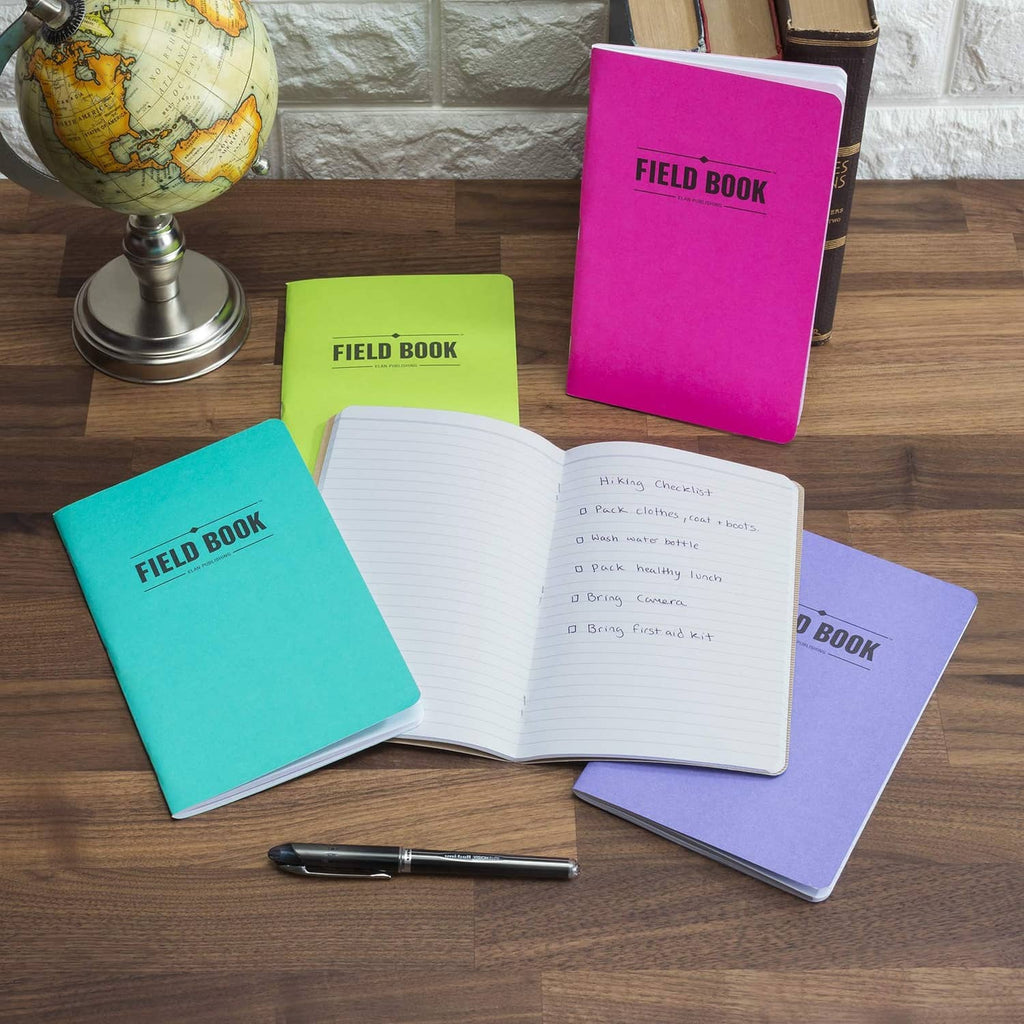 Open lined notebook with white ruled pages; Field Book covers in teal, pink, and purple