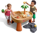 Kids dinosaur sand and water play table with green palm tree, tan basin, grey accessory tray