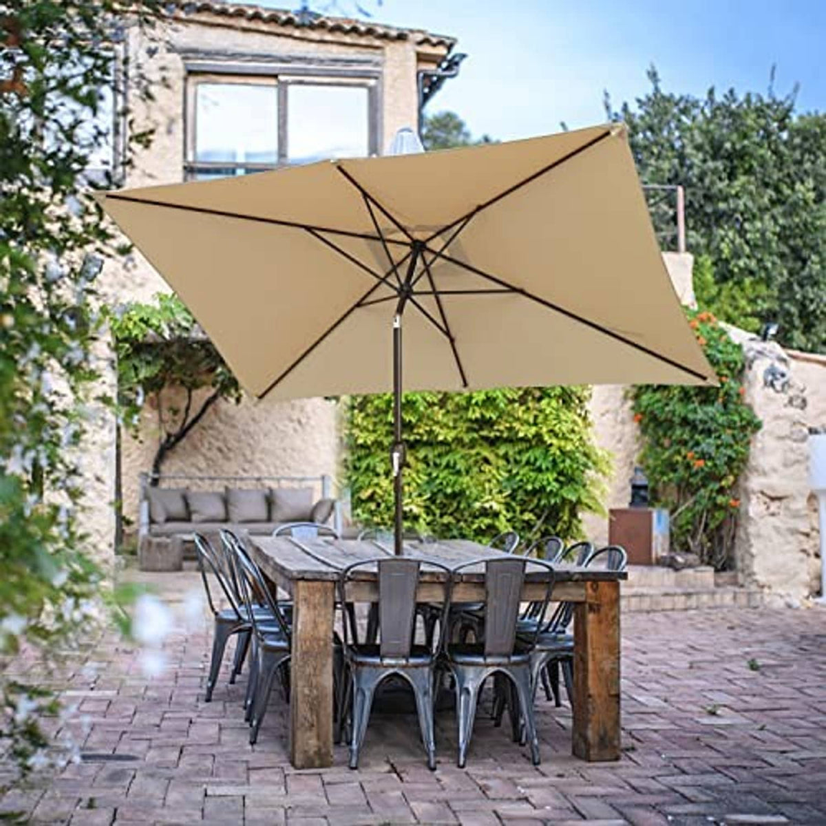 Tan rectangular patio umbrella on black pole with cross-braced rib frame