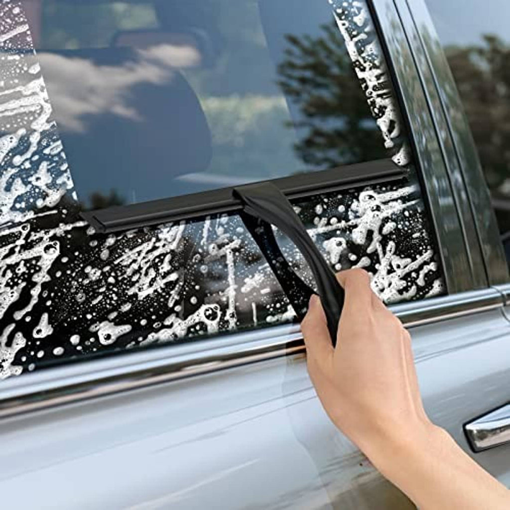 Black shower squeegee used on wet car windshield glass