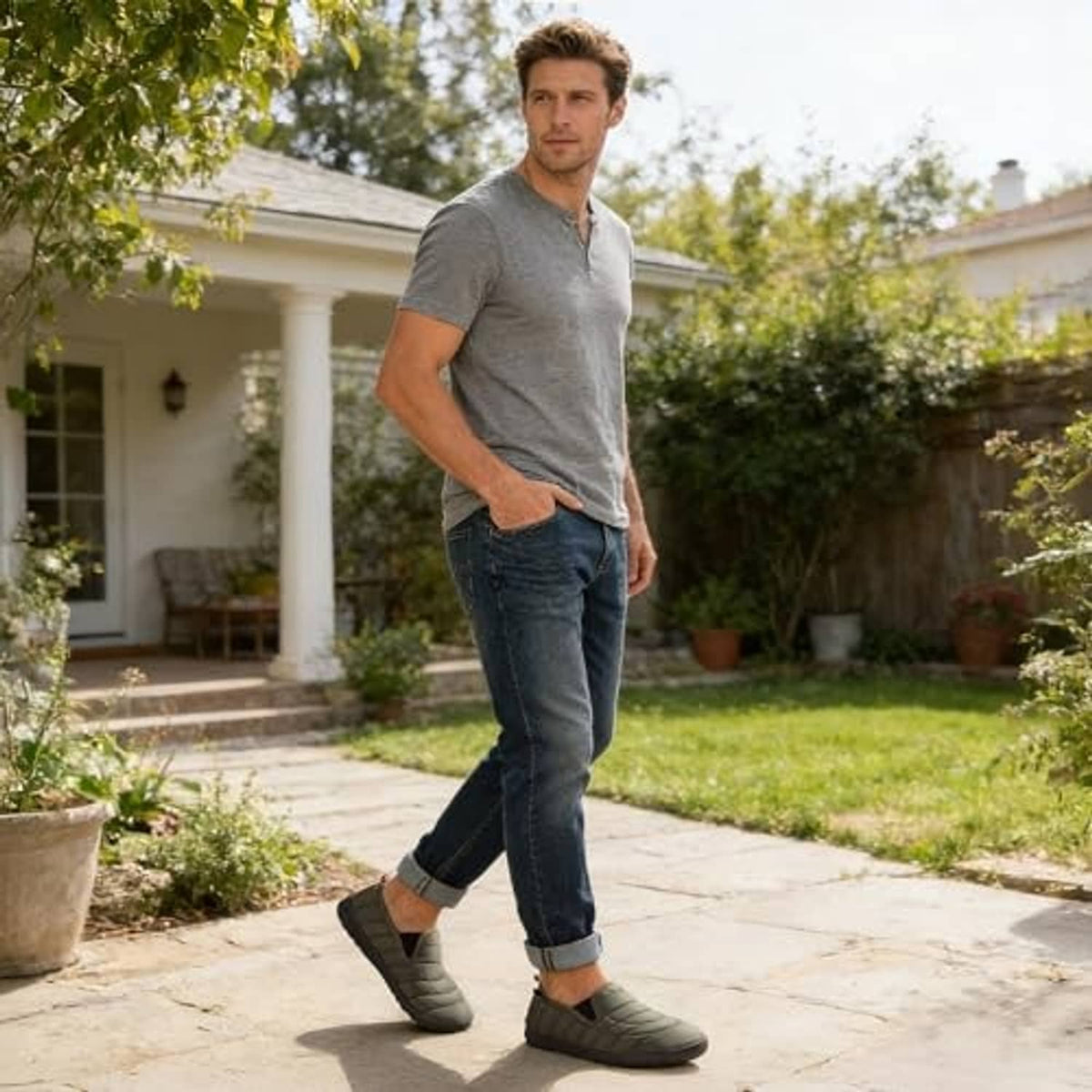 Men's army green slip-on slippers on model, quilted upper and dark gripped sole