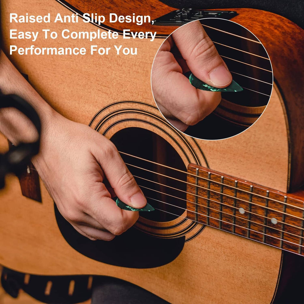 Raised-dot non-slip guitar pick in use on acoustic guitar strings; hands holding pick at angle.
