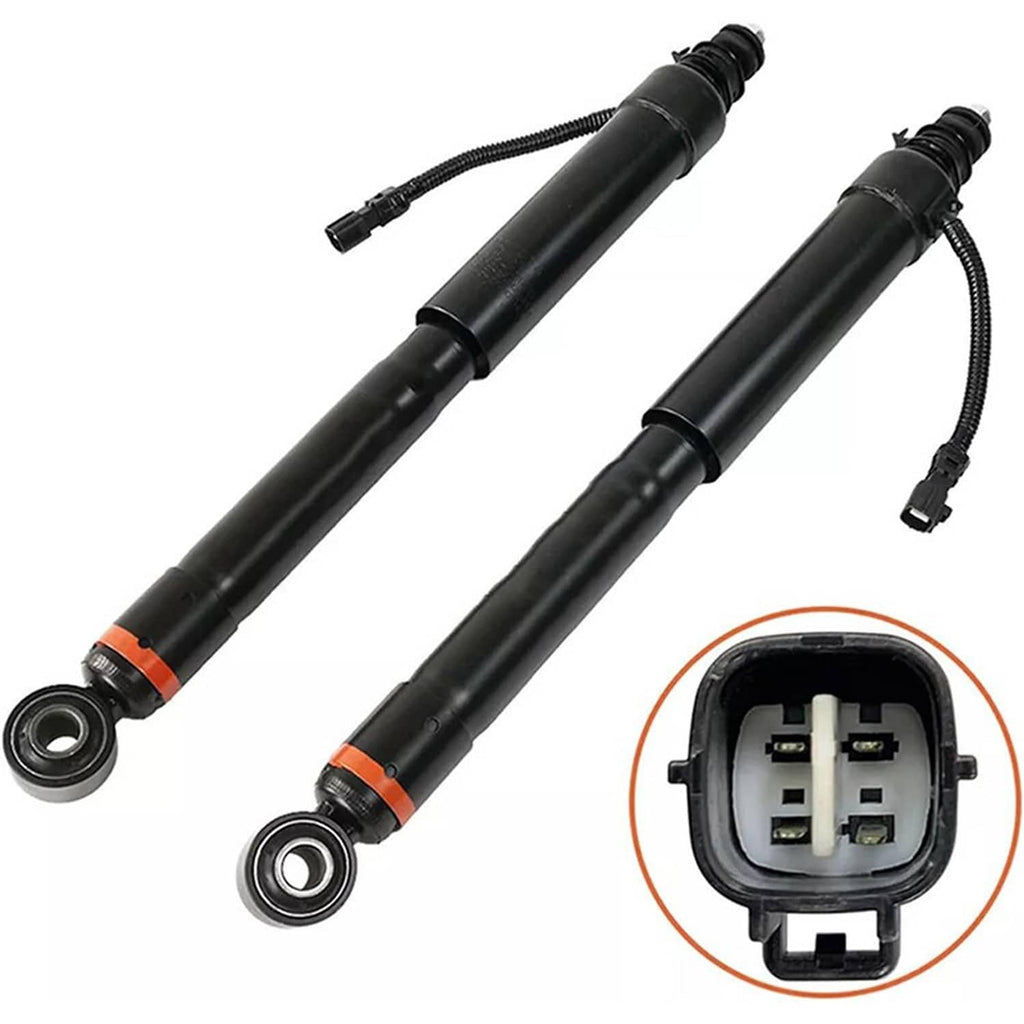 Two shock strut assemblies with black cylinders, orange markings, and connector plug