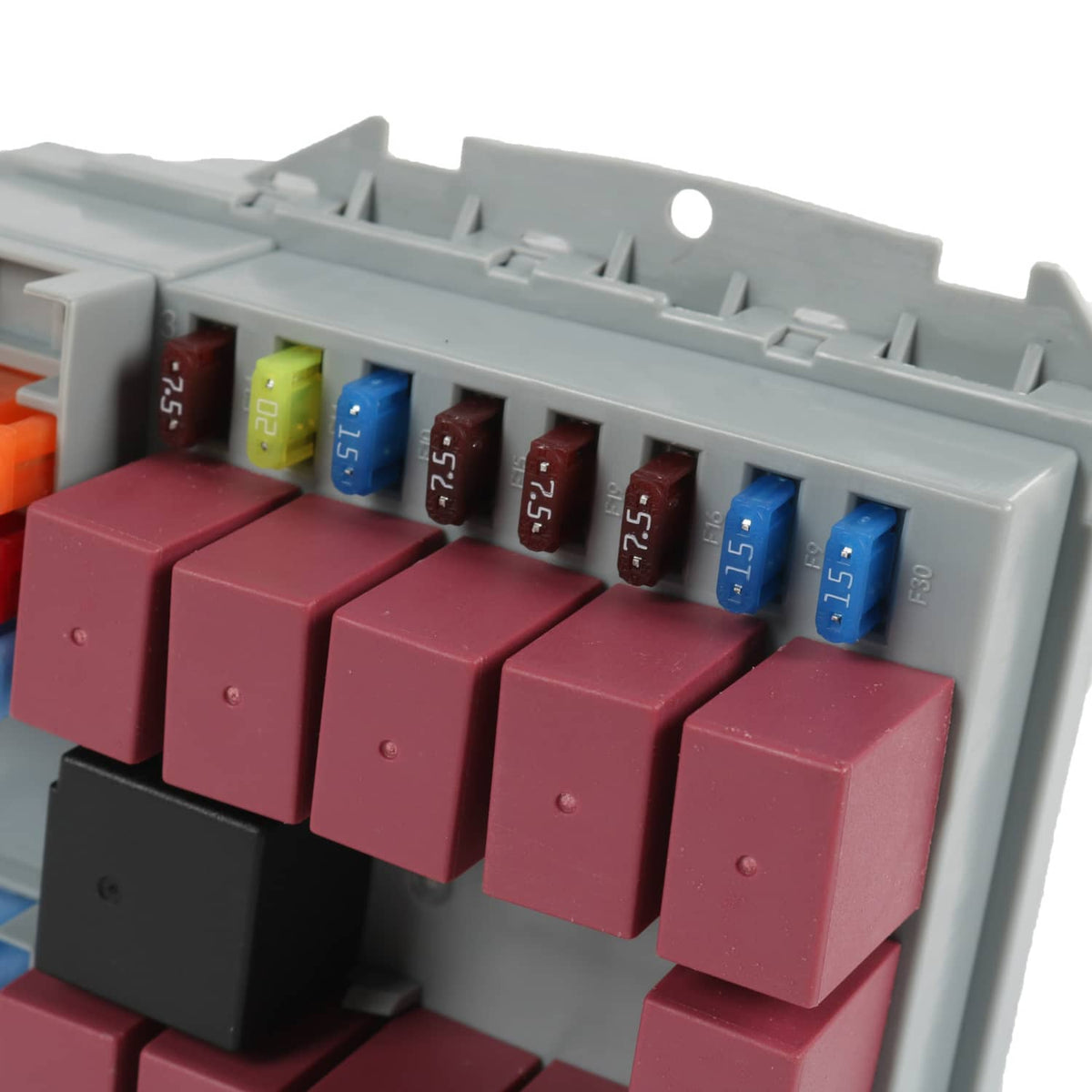 Power distribution center with red and black blade fuses installed in gray housing