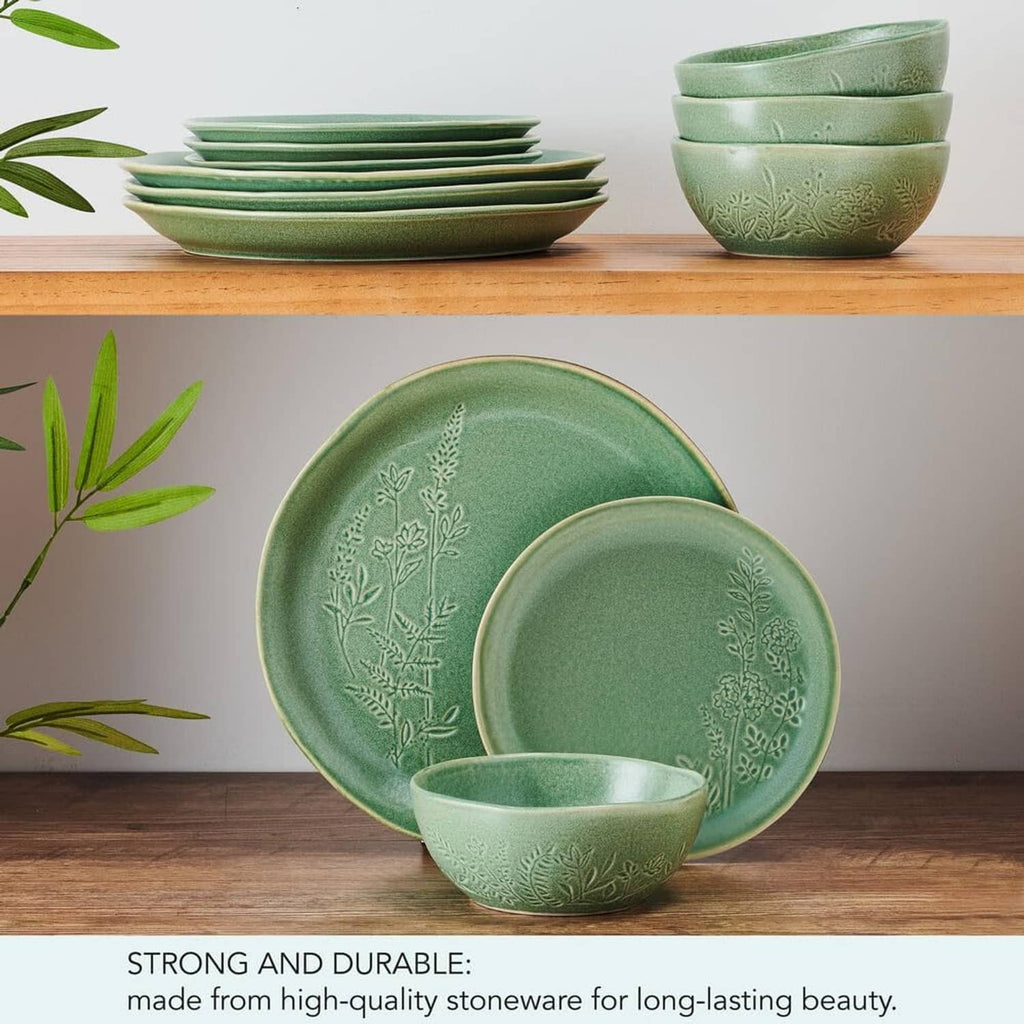 Green dinnerware set with embossed botanicals: plates and bowls on display