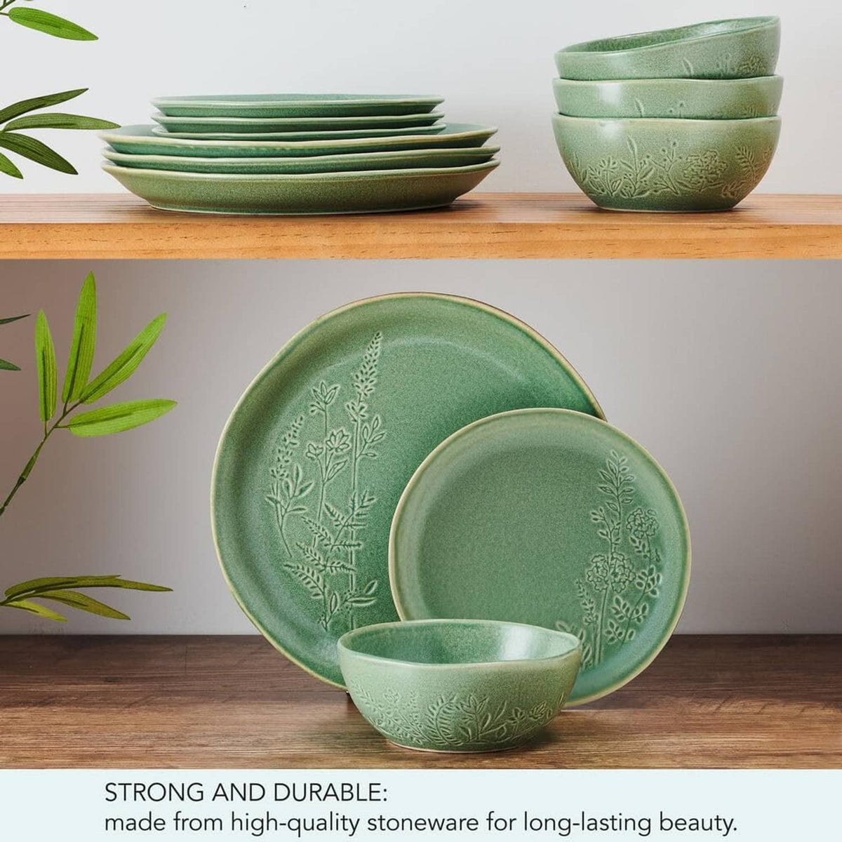 Green dinnerware set with embossed botanicals: plates and bowls on display