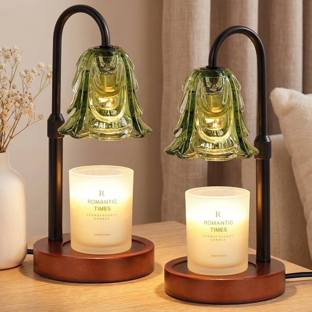 Green glass candle warmer lamp with black arch stand, glowing jar candle on wood base