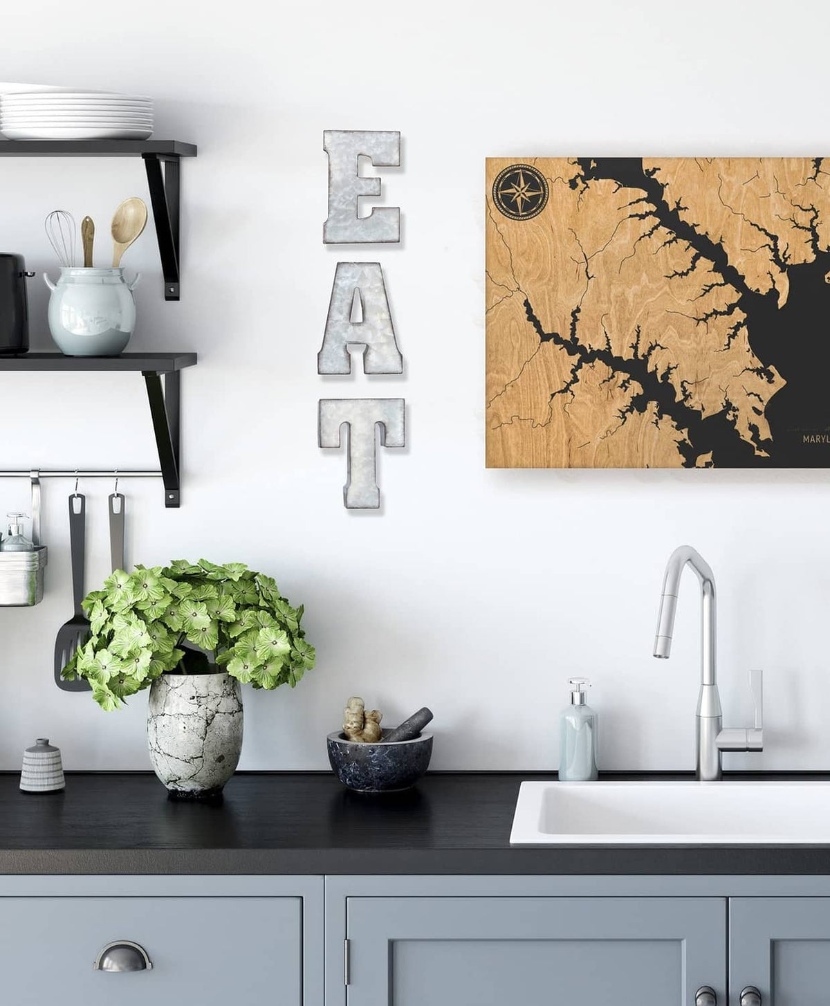 Silver Eat letter metal sign mounted on wall above kitchen counter