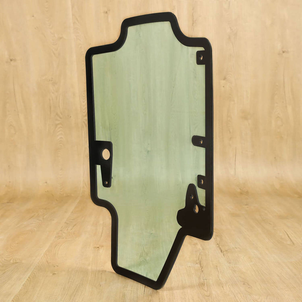 Skid steer door glass panel with black frame and mounted hardware, tinted light green