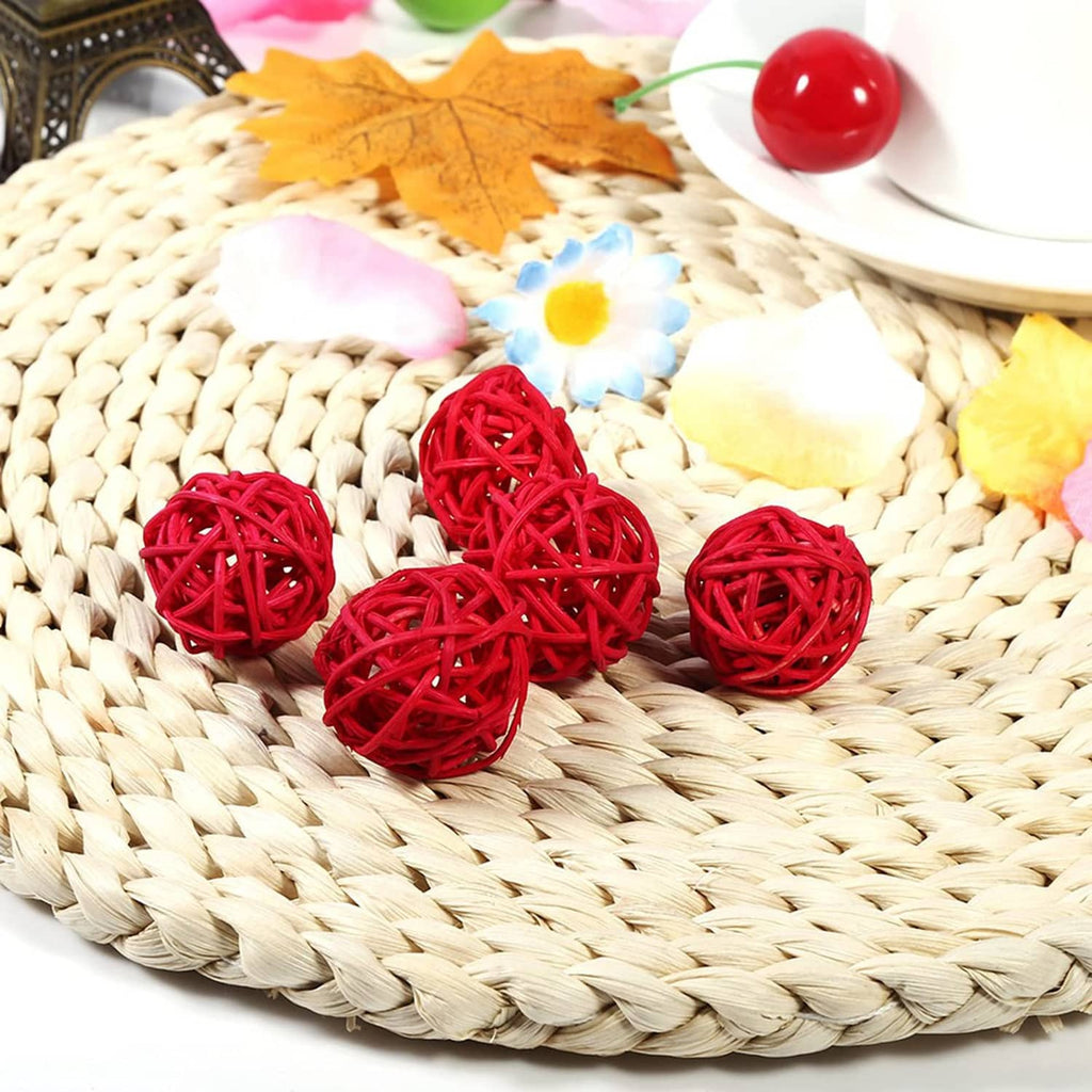 Red woven wicker rattan balls on a straw wreath surface, decorative set