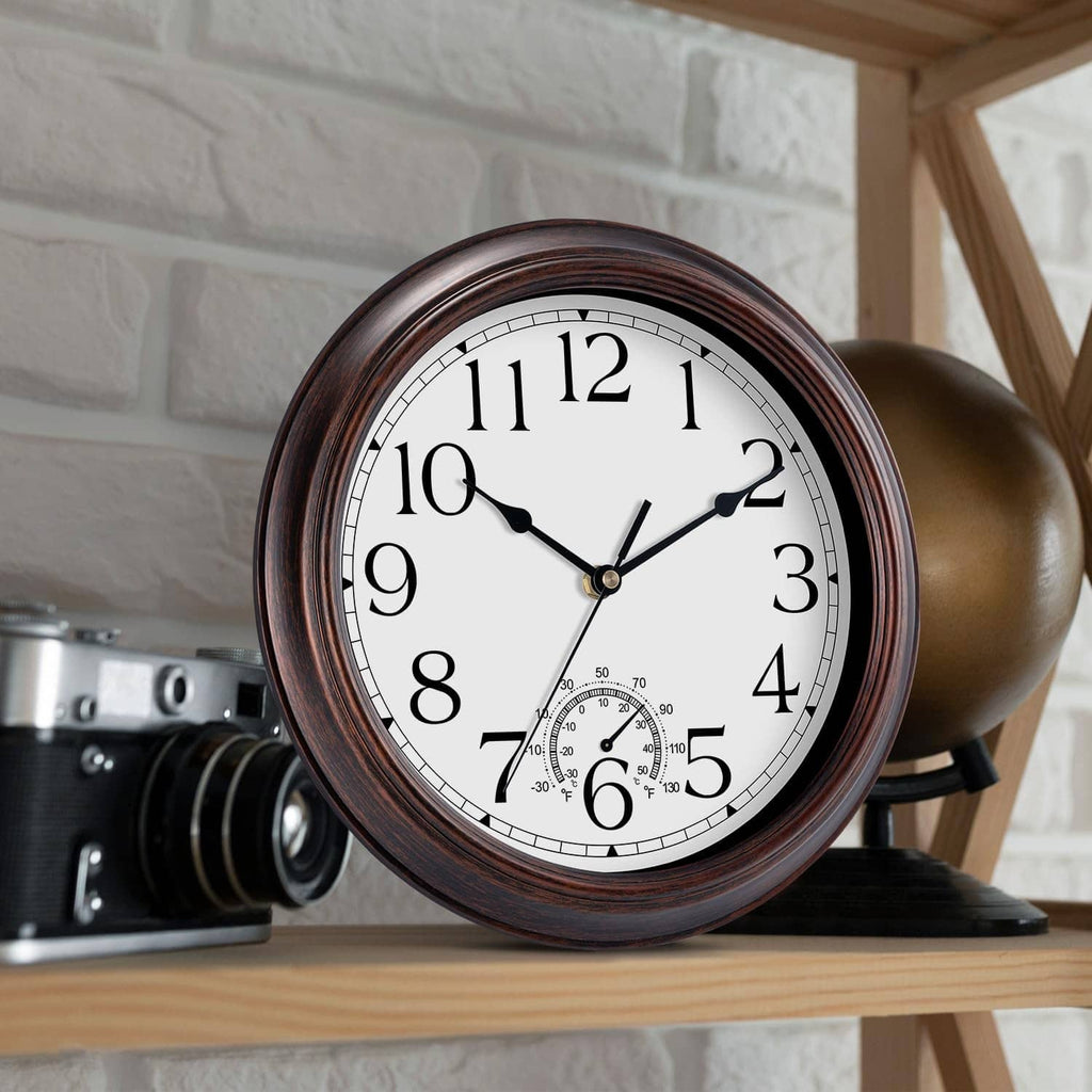Outdoor wall clock with copper-red frame, large numerals, and thermometer subdial at bottom.