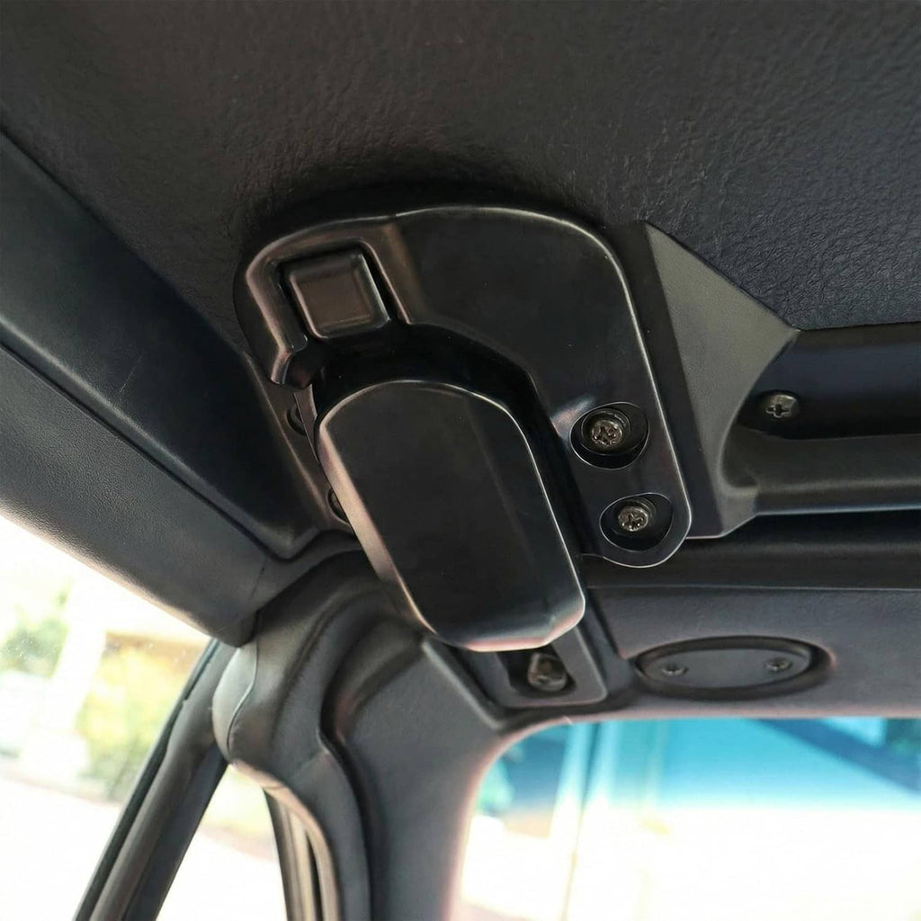 Close-up of black soft-top roof latch lock on convertible interior with screws
