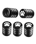 Black metal tire valve stem caps with paw print emblem and ridged textured grip.