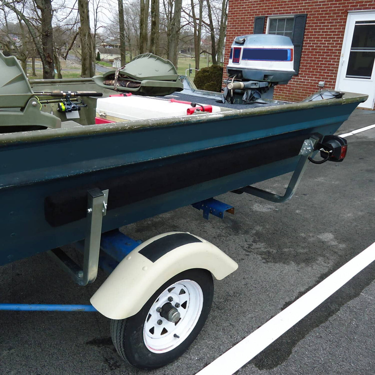 Boat trailer bunk board guide installed on teal trailer rail with black guide blocks and brackets