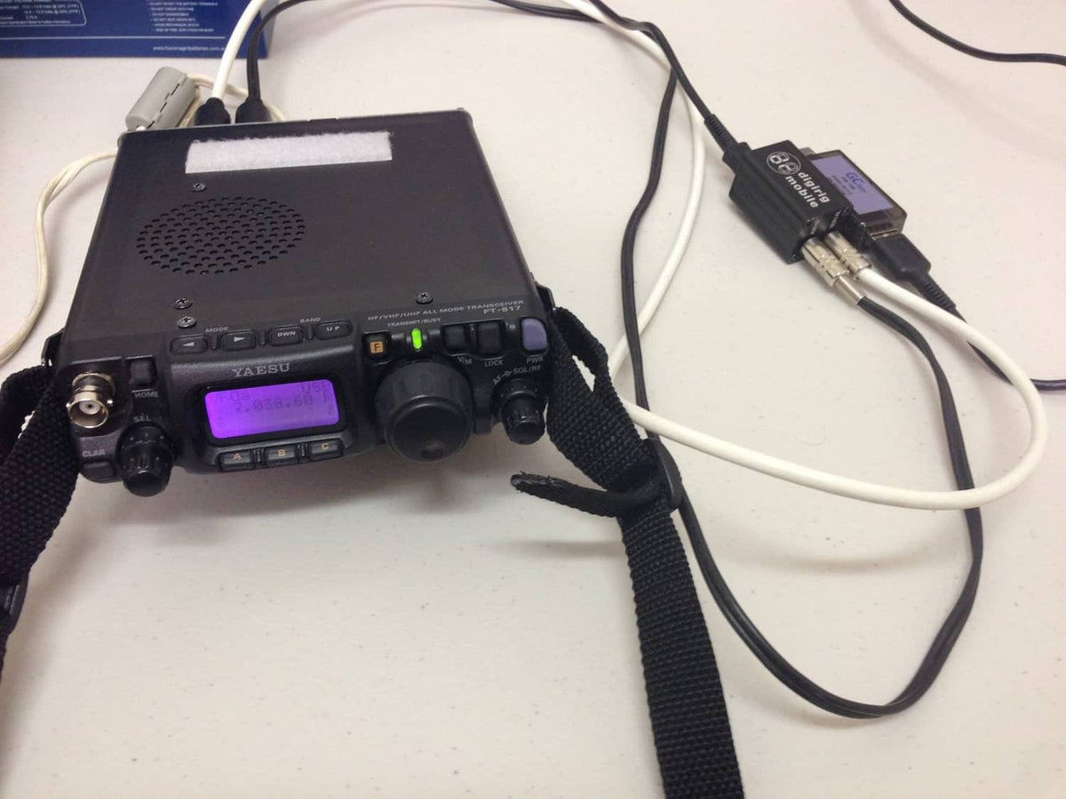 Digital modes interface unit with purple display, mic/audio controls, and connected cables