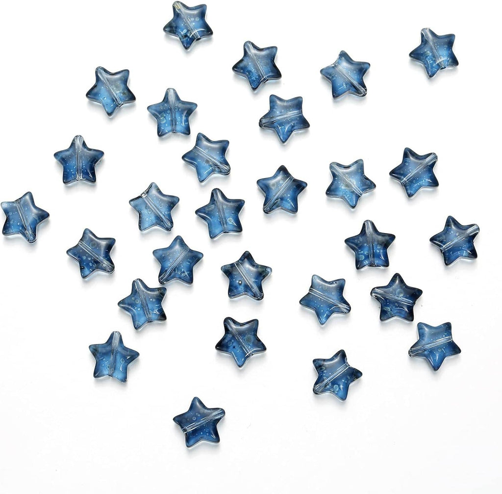 Dark blue star glass spacer beads scattered on a white surface