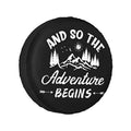 Black spare tire cover with mountain “Adventure Begins” graphic