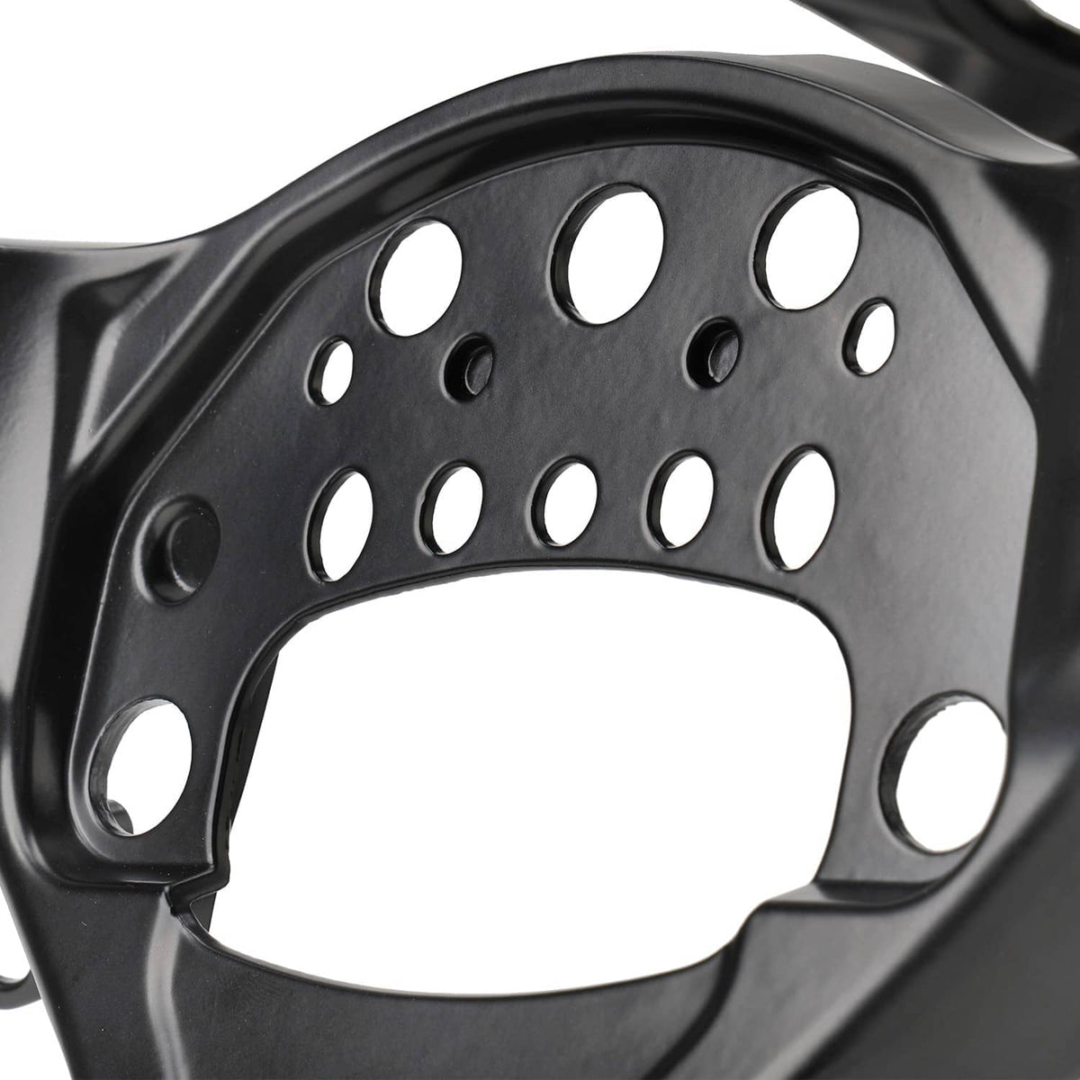 Close-up of black fairing stay bracket plate with circular and oval mounting holes