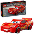 Retail box and red buildable Lightning McQueen-style race car toy, front three-quarter view