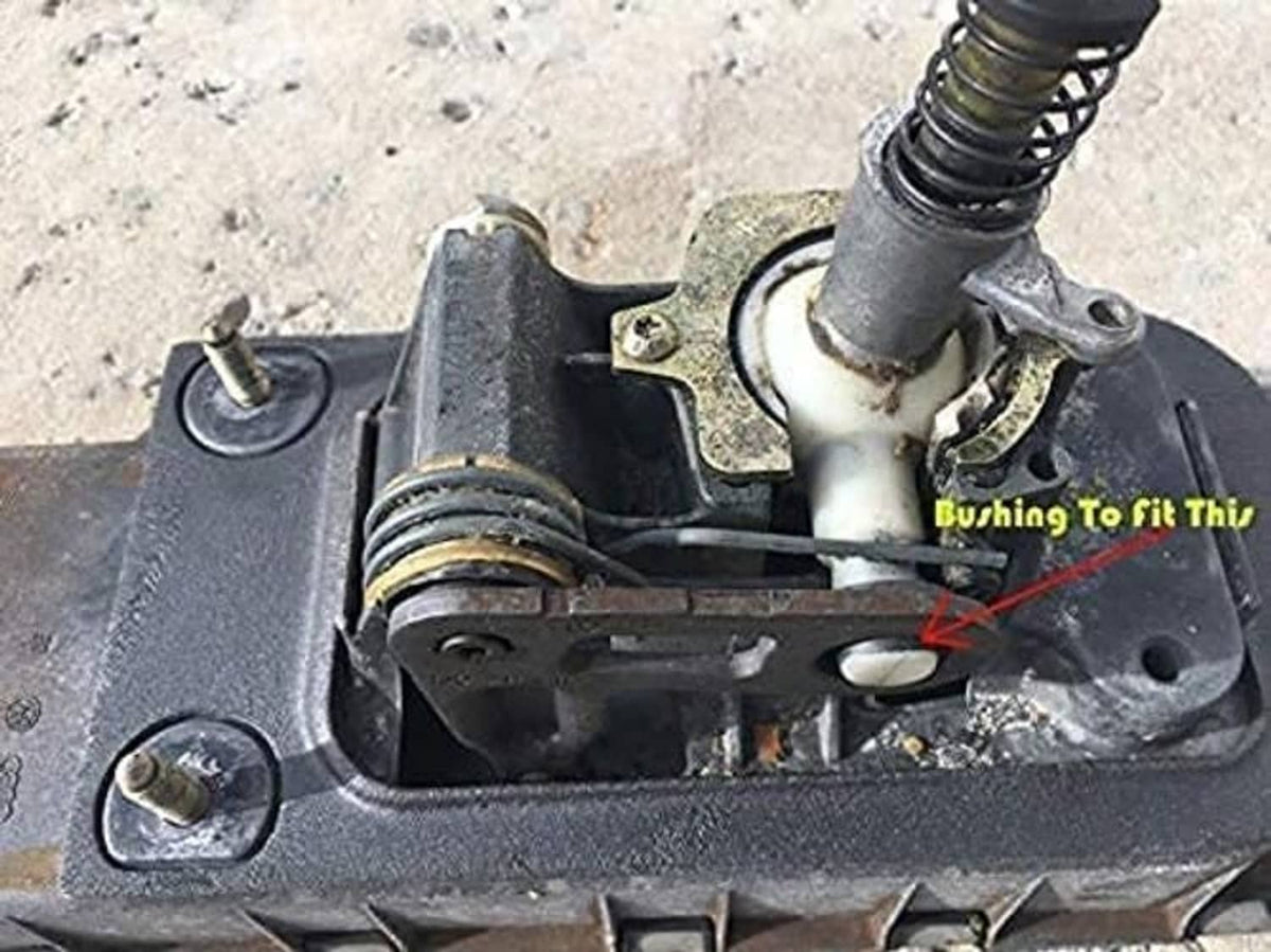 Rubber bushing seated in metal bracket on automotive part