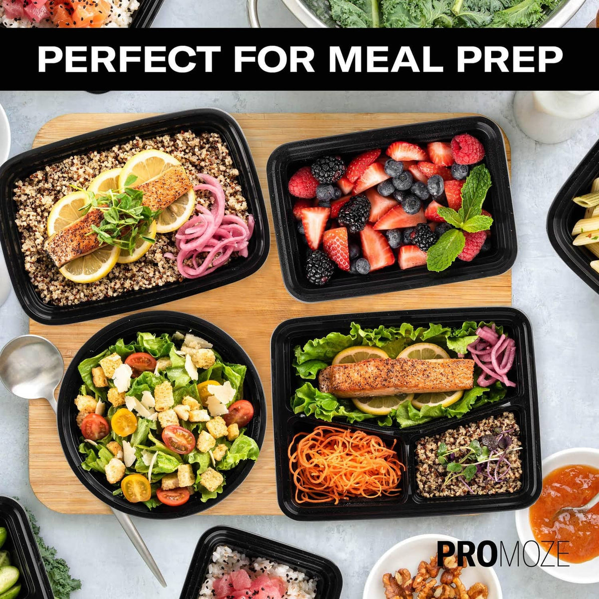 Multiple black meal prep containers with assorted meals: salad, pasta, berries, and more