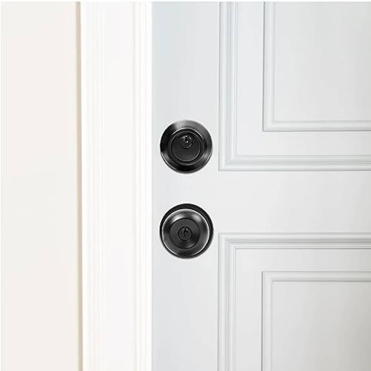 Matte black deadbolt and keyed knob installed on a white exterior door