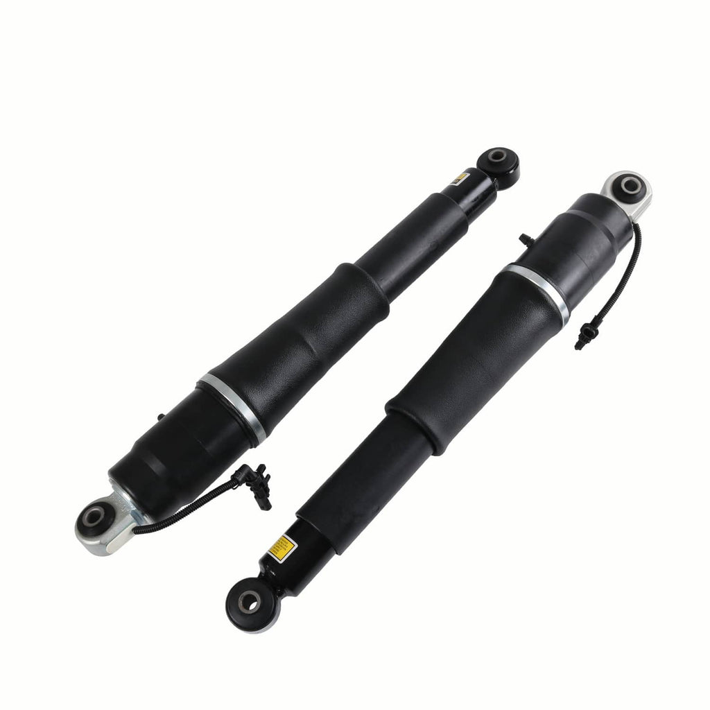 Two black rear air shock absorbers with metal eyelet mounts and wiring on the side