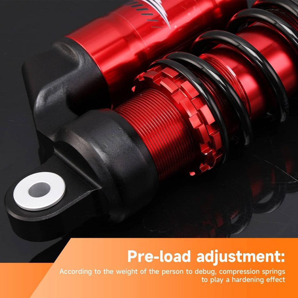 Rear shock absorber close-up with red reservoir, black coil spring, and mounting eye